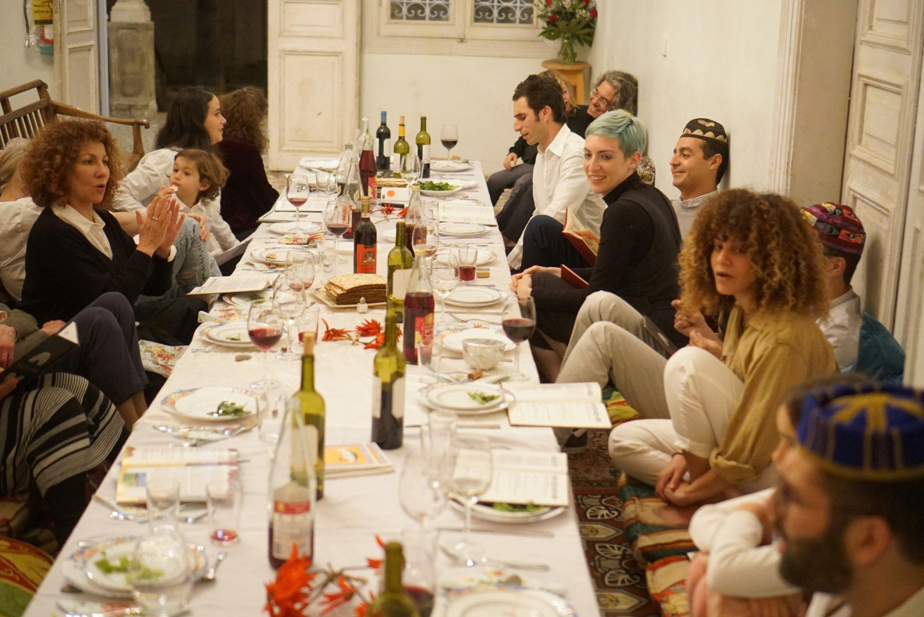 Guests sharing a long table dinner with wine